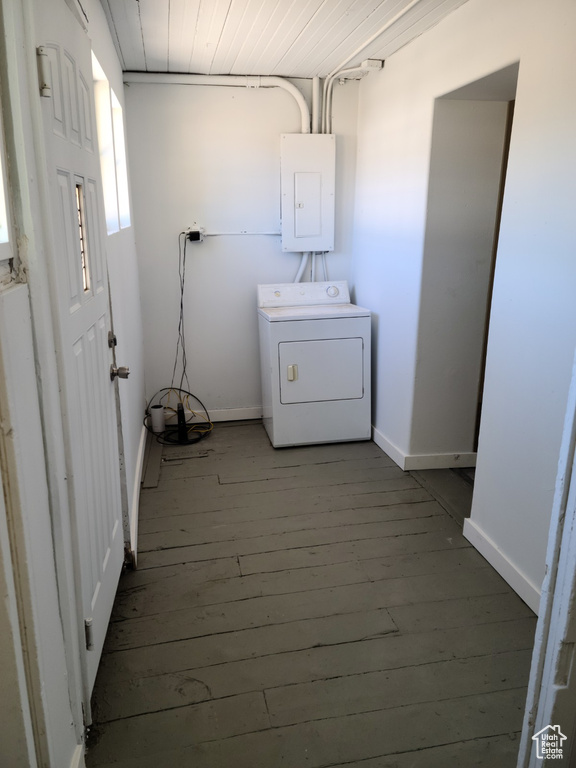 Washroom with washer / clothes dryer, electric panel, wood-type flooring, and baseboards