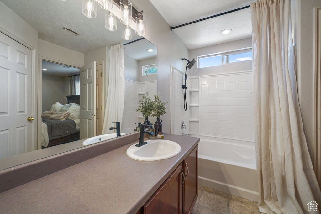 Ensuite bathroom with shower / tub combo with curtain and vanity