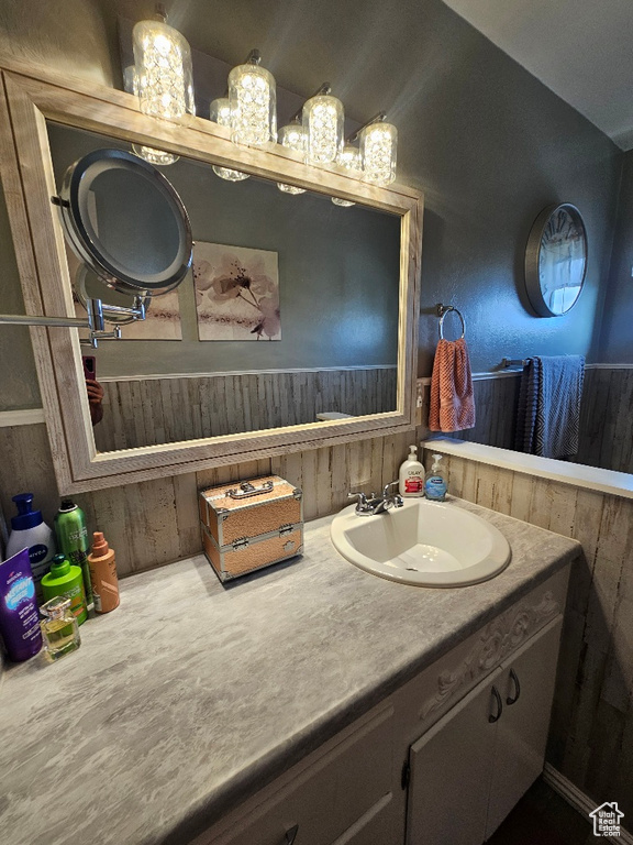Bathroom with wood walls and vanity