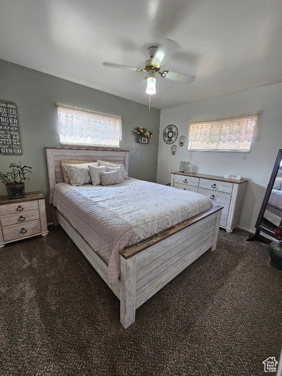 Bedroom with dark carpet and ceiling fan