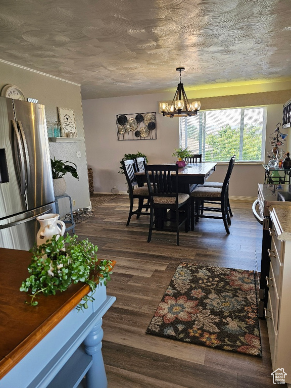 Dining area featuring a chandelier and dark wood finished floors