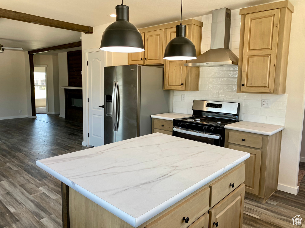 Kitchen with wall chimney range hood, stainless steel appliances, backsplash, dark wood-type flooring, and light brown cabinetry
