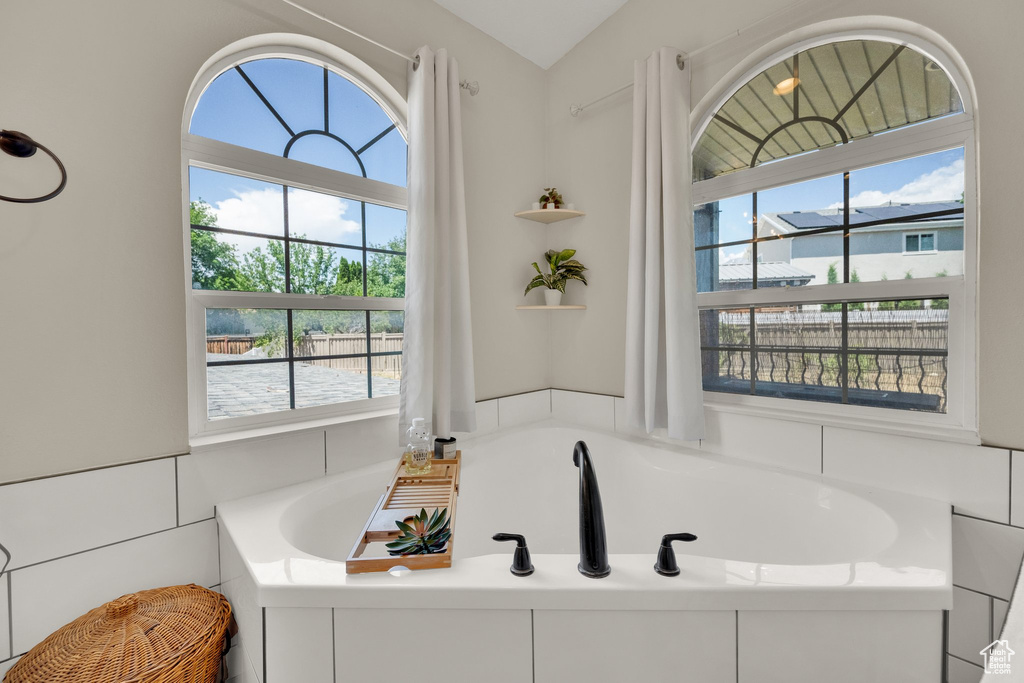 Full bath featuring a garden tub and plenty of natural light