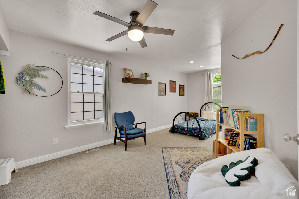 Carpeted bedroom with ceiling fan and recessed lighting