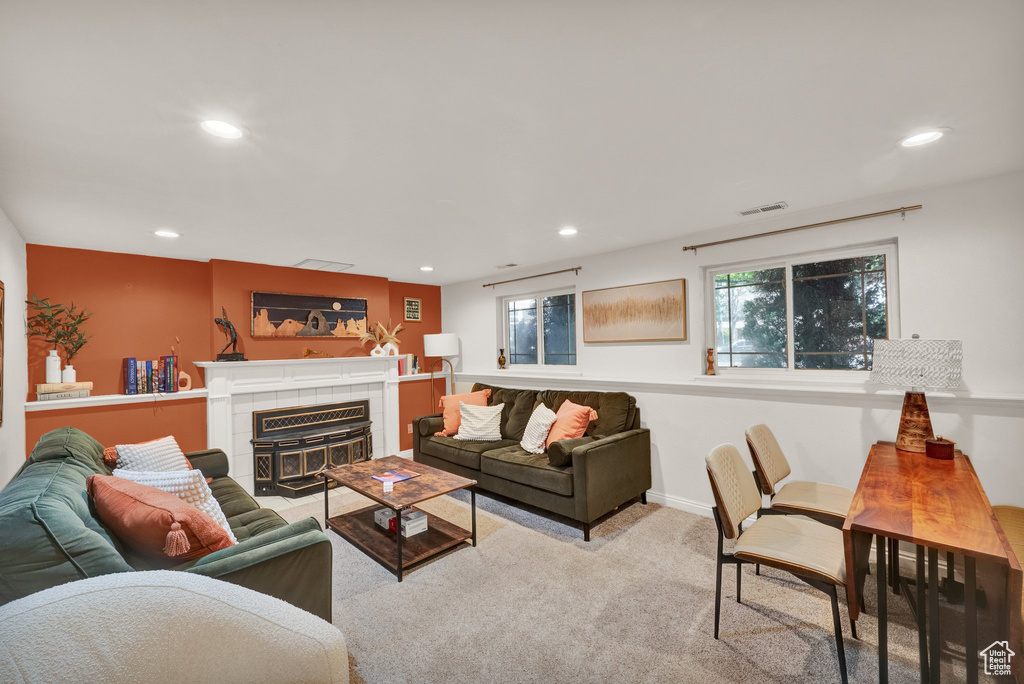 Living room with recessed lighting, carpet, and a tile fireplace
