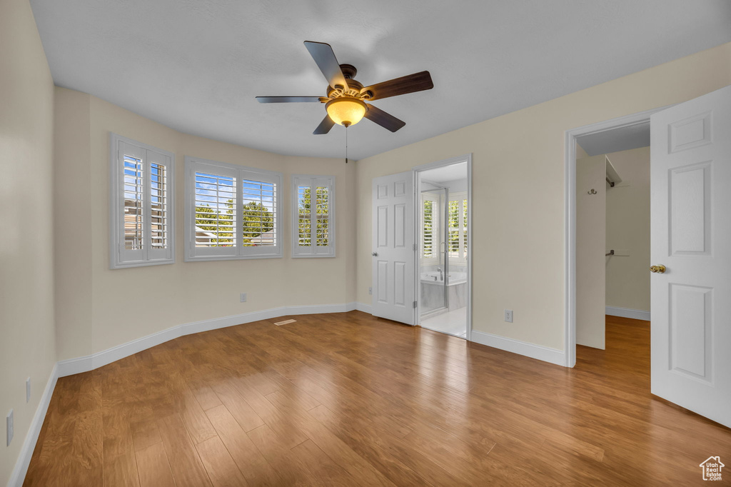 Unfurnished room with a ceiling fan and wood finished floors