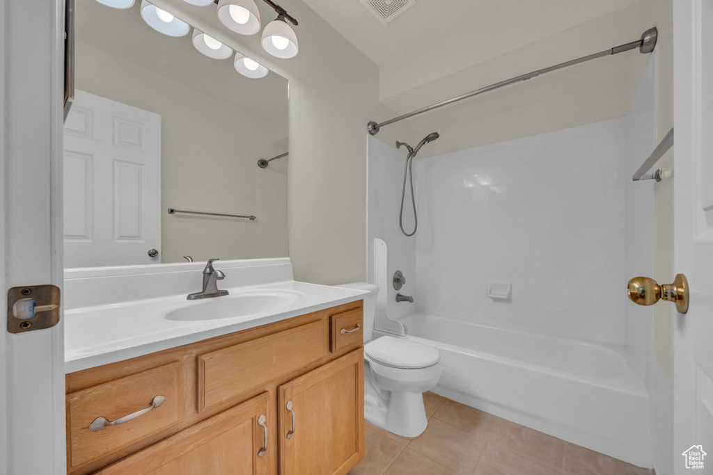 Full bath with tile patterned flooring,  shower combination, and vanity
