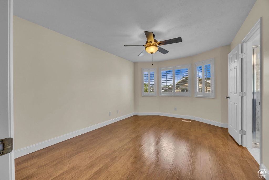 Unfurnished bedroom with light wood finished floors and ceiling fan