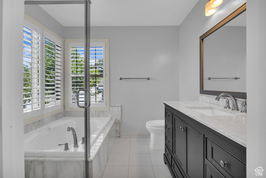 Full bathroom featuring vanity, a garden tub, and tile patterned floors