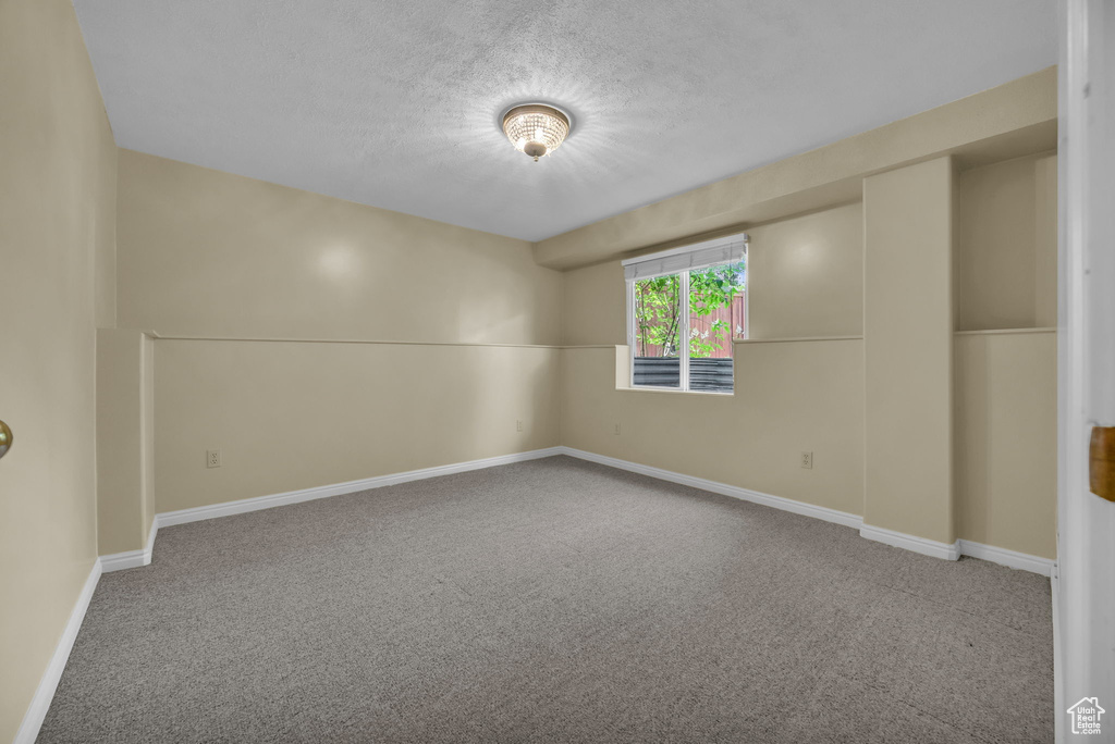 Spare room with carpet flooring and a textured ceiling