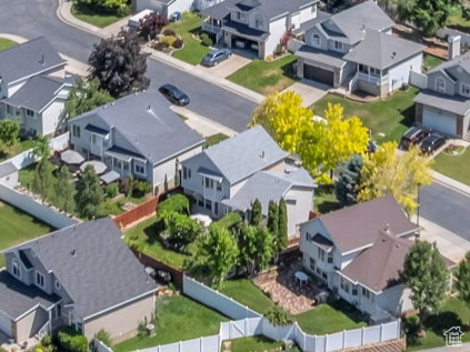 Aerial view of property and surrounding area with a mountain backdrop