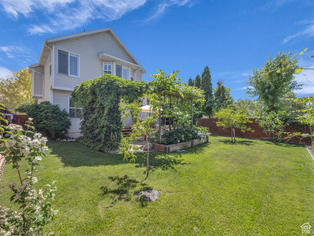 Fenced backyard with a vegetable garden