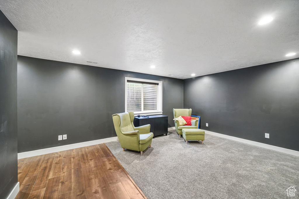 Living area featuring wood finished floors and recessed lighting