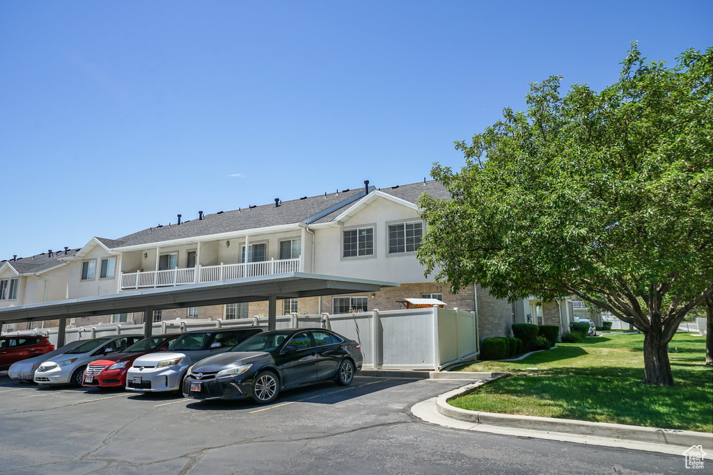View of property featuring covered parking and a residential view