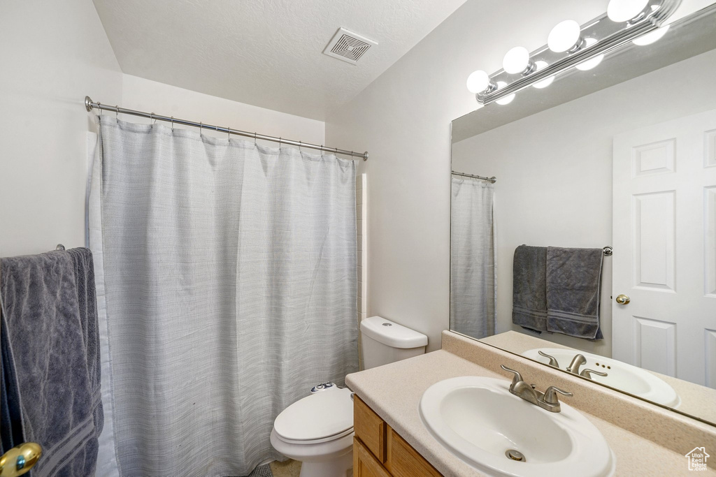 Bathroom with vanity and a shower with shower curtain