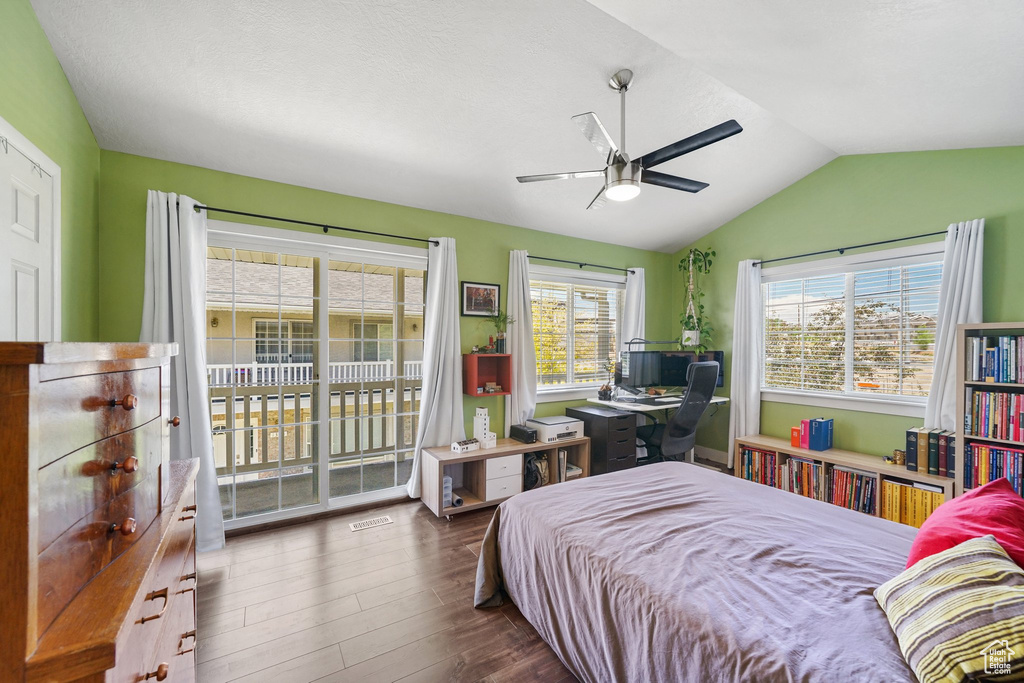 Bedroom with access to outside, lofted ceiling, wood finished floors, and a ceiling fan