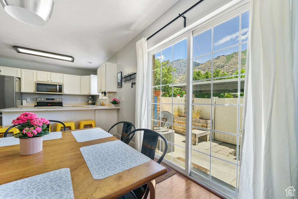 Dining space with light wood-style floors and a mountain view