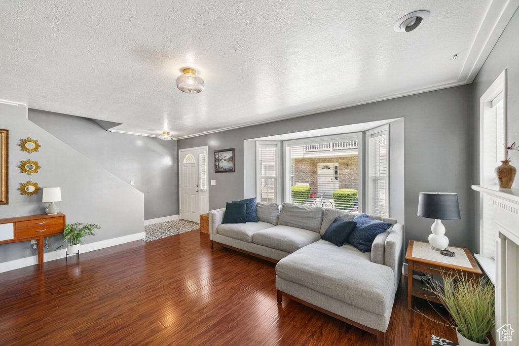 Living room with a textured ceiling and wood finished floors