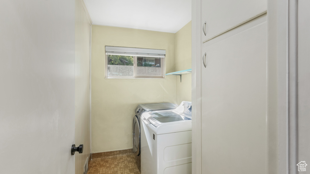 Washroom with washer and clothes dryer
