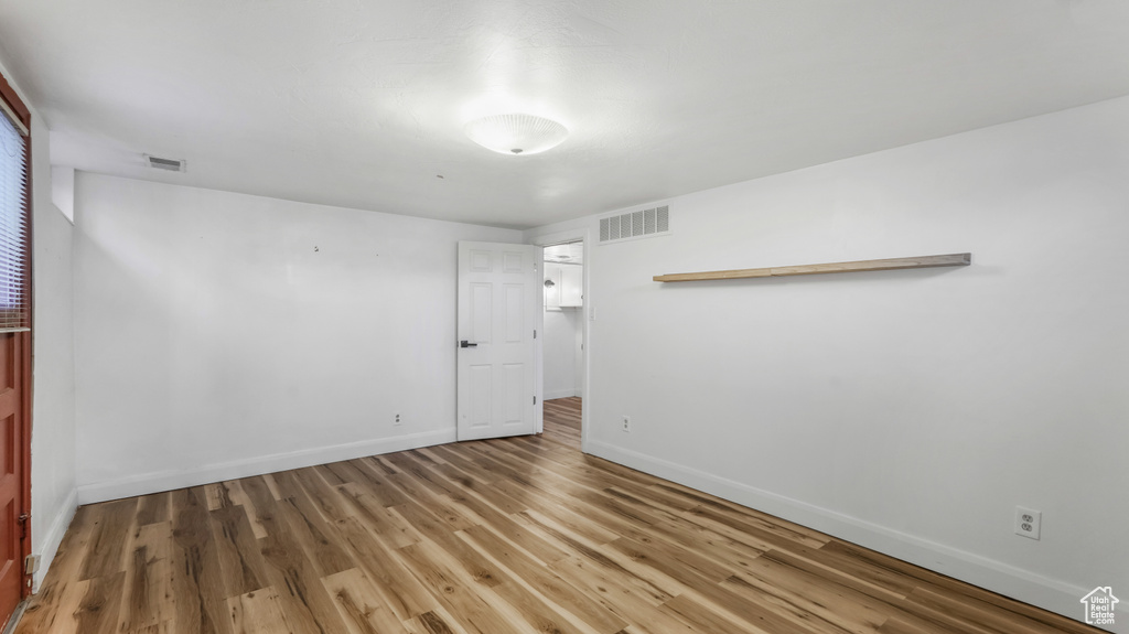 Unfurnished bedroom featuring baseboards and wood finished floors