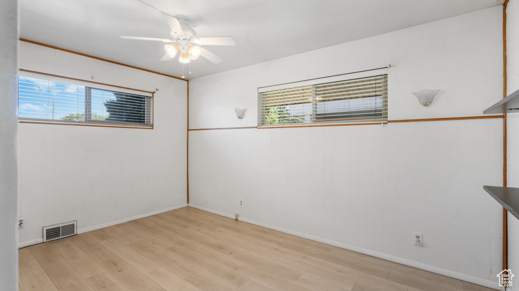 Empty room with light wood-style flooring and a ceiling fan