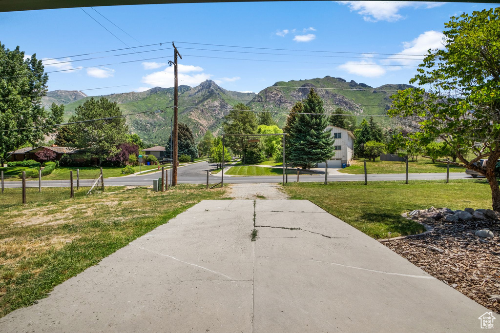 View of community featuring a mountain view and a lawn