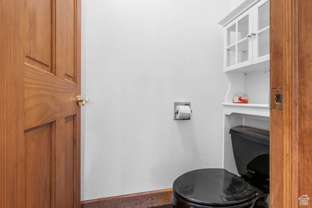 Bathroom with toilet and baseboards