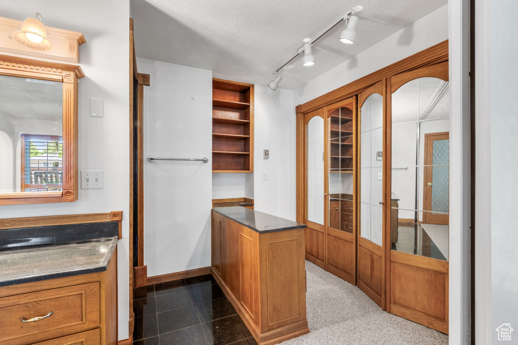 Unfurnished office with baseboards and rail lighting