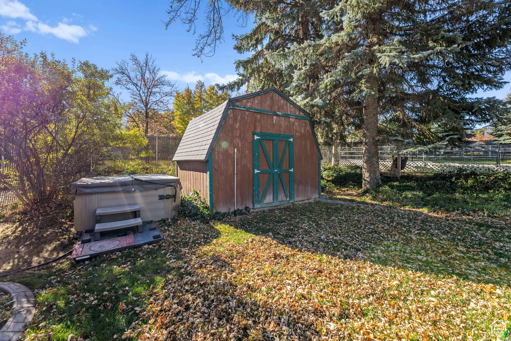 View of shed with a hot tub