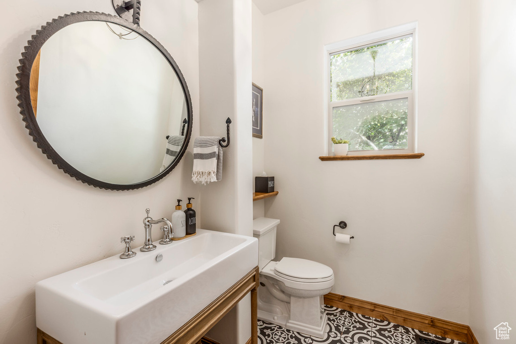 Half bathroom featuring vanity and toilet