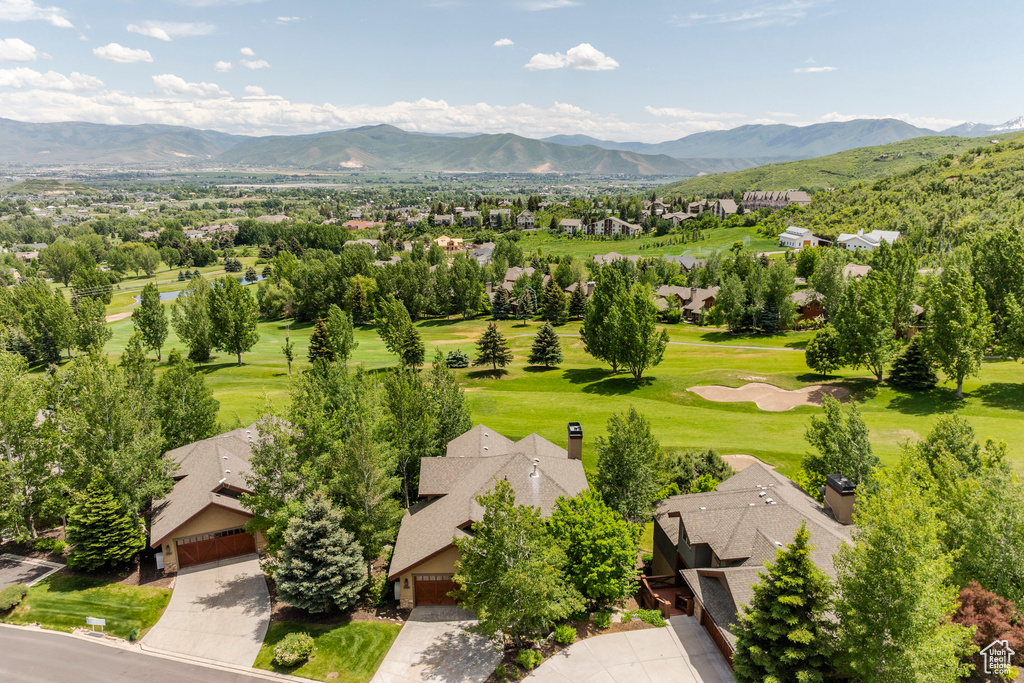 Aerial view of residential area featuring mountains and a golf course