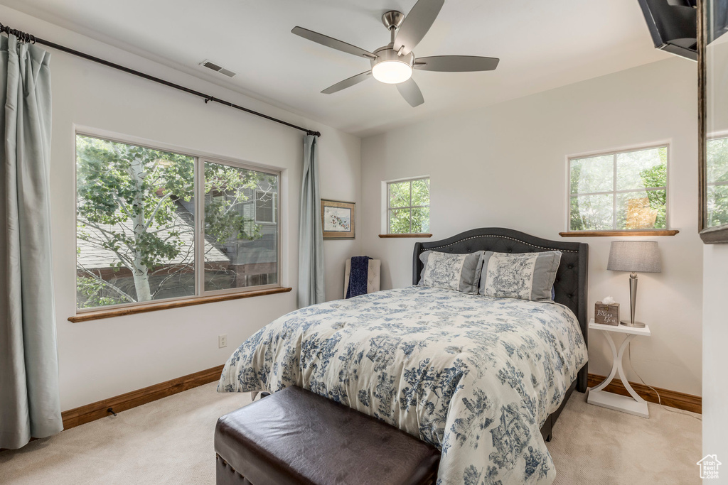 Bedroom with light carpet and ceiling fan
