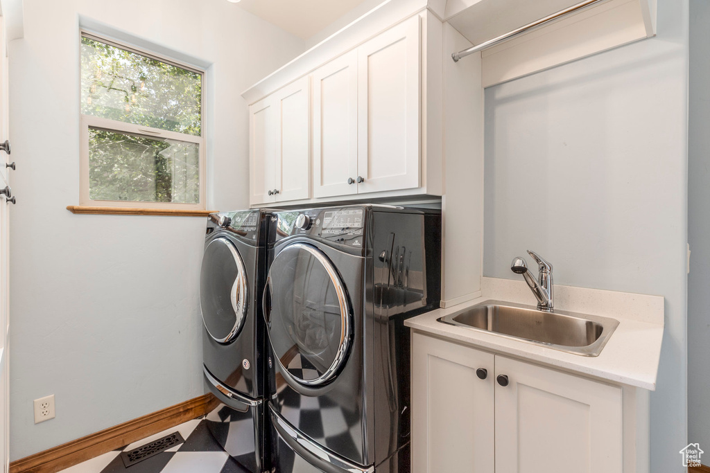 Laundry room featuring cabinet space and washer and dryer