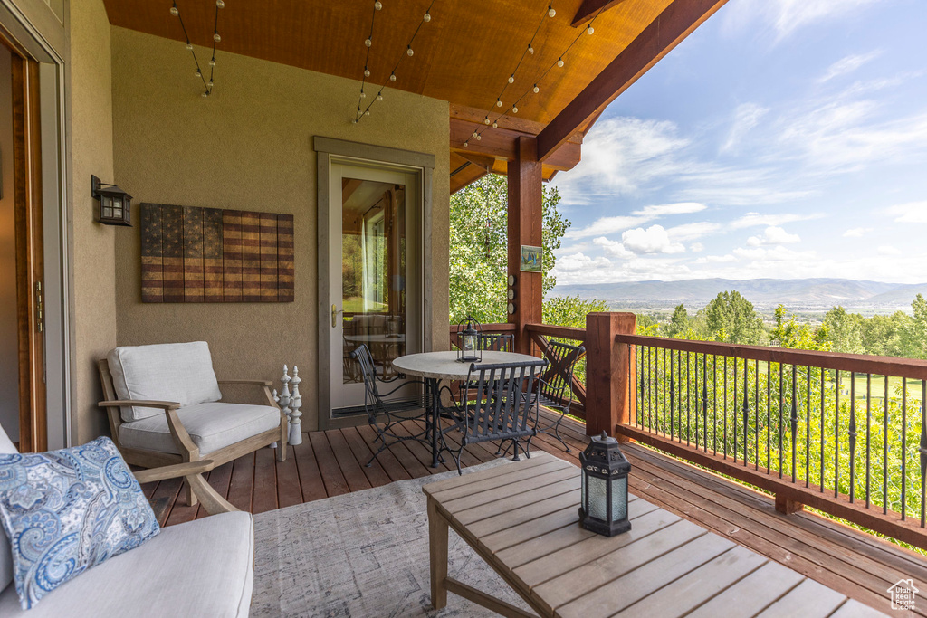 Wooden terrace with a mountain view and outdoor dining space