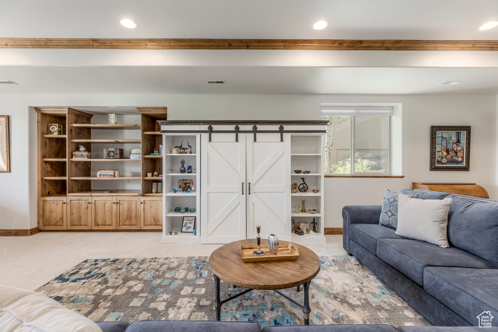 Living area with recessed lighting and ornamental molding