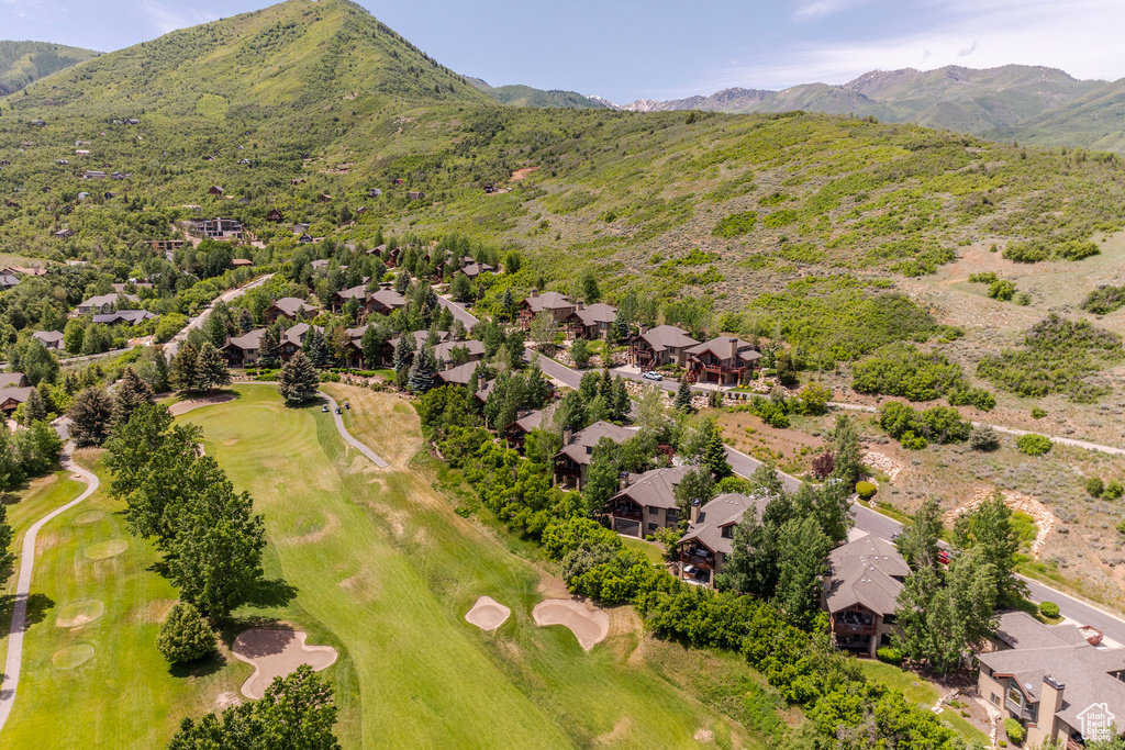 Aerial perspective of suburban area with a local golf course and mountains