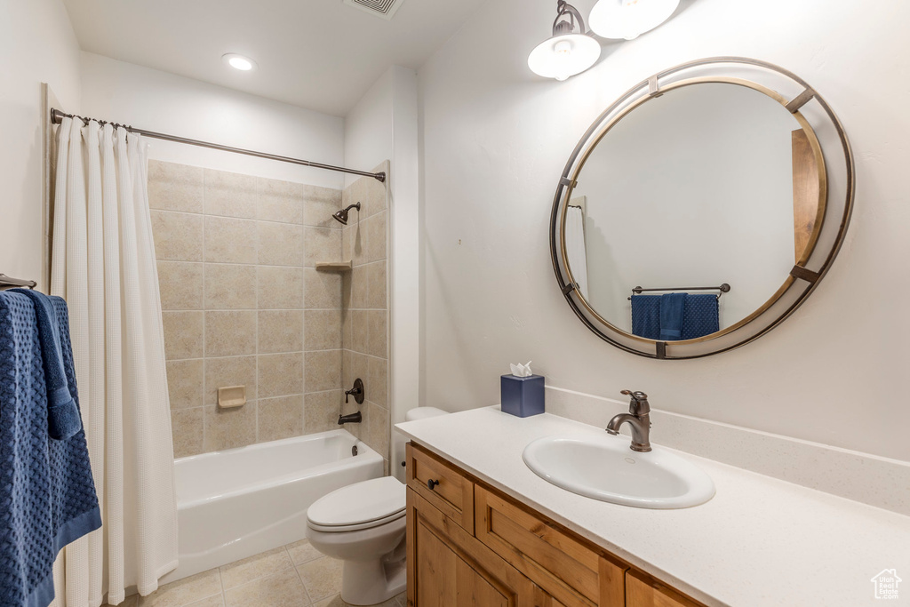 Full bathroom featuring shower / bath combo, vanity, and tile patterned floors