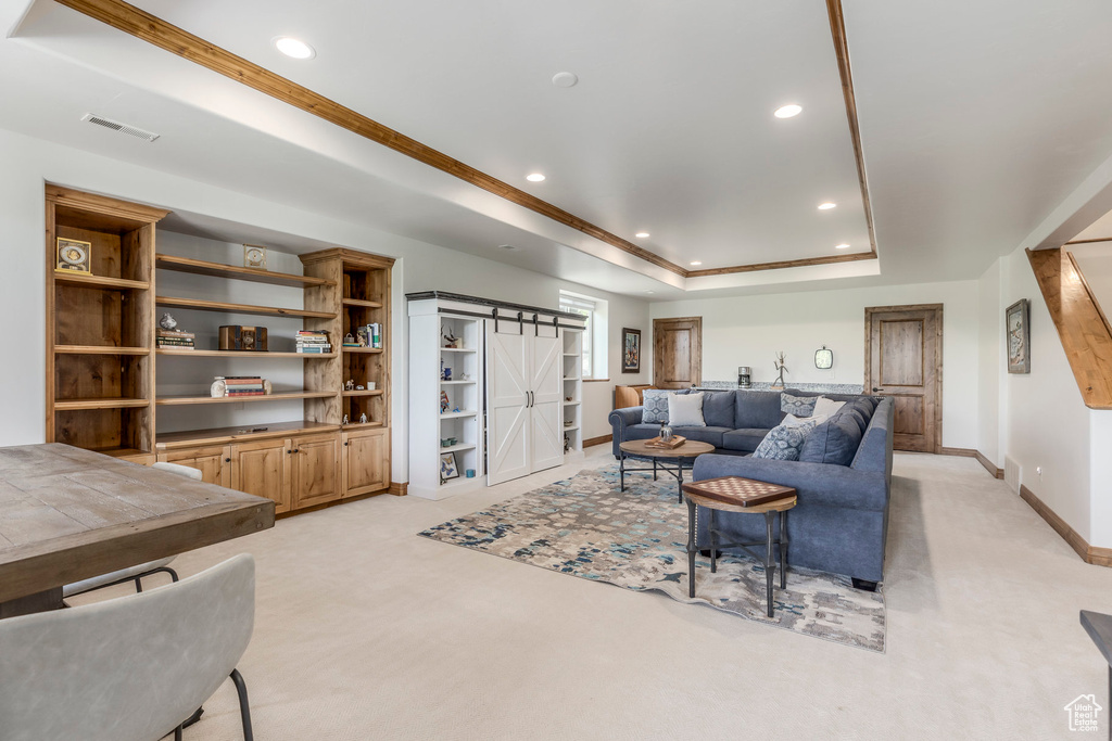 Living room featuring light colored carpet, recessed lighting, and a raised ceiling