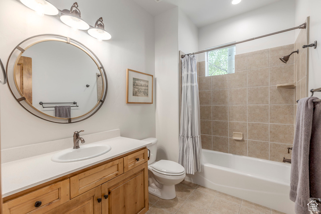 Bathroom with vanity, shower / bath combination with curtain, and tile patterned floors