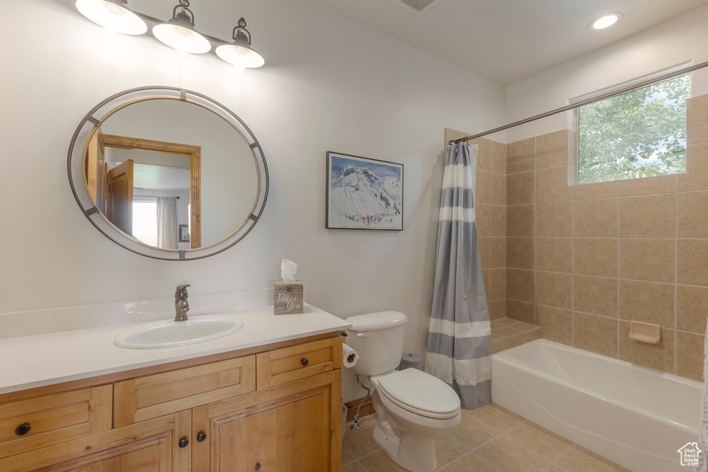 Full bath featuring tile patterned floors, vanity, and shower / tub combo with curtain