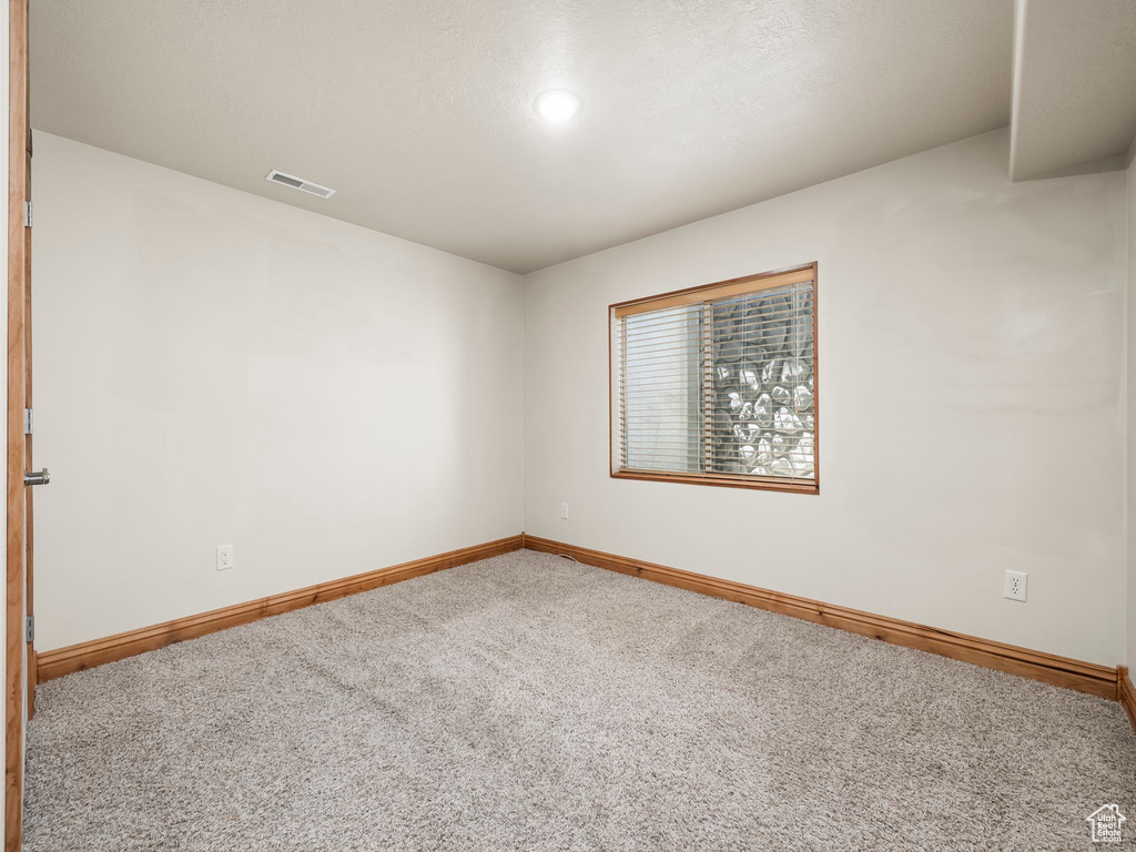 Empty room with carpet floors and recessed lighting