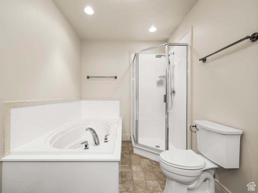 Full bathroom featuring a stall shower, a garden tub, and recessed lighting