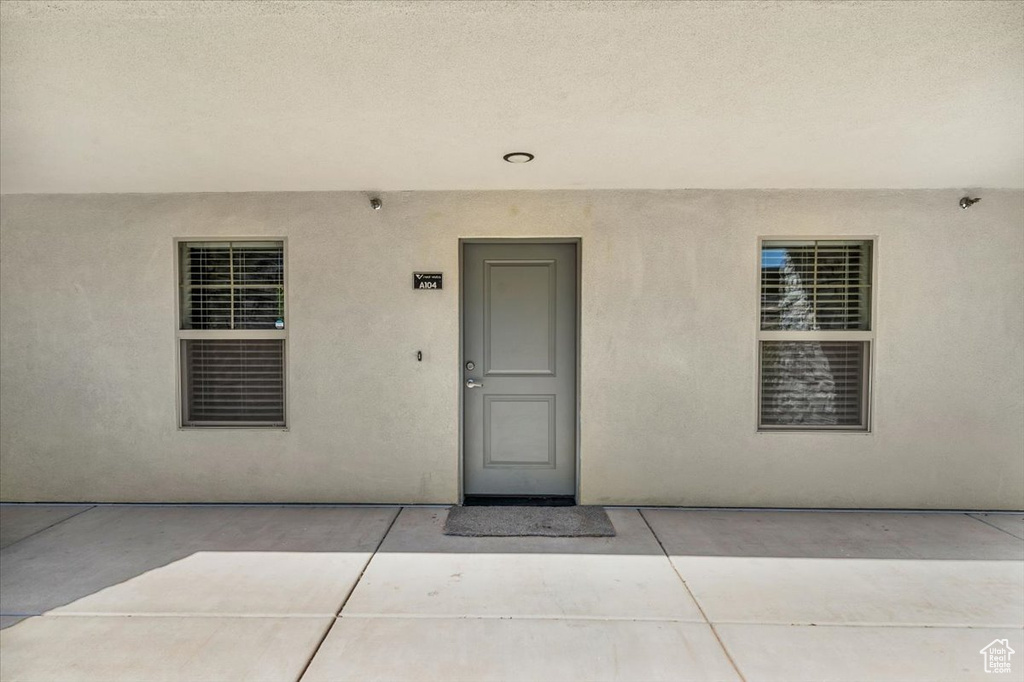 Property entrance featuring a patio area and stucco siding