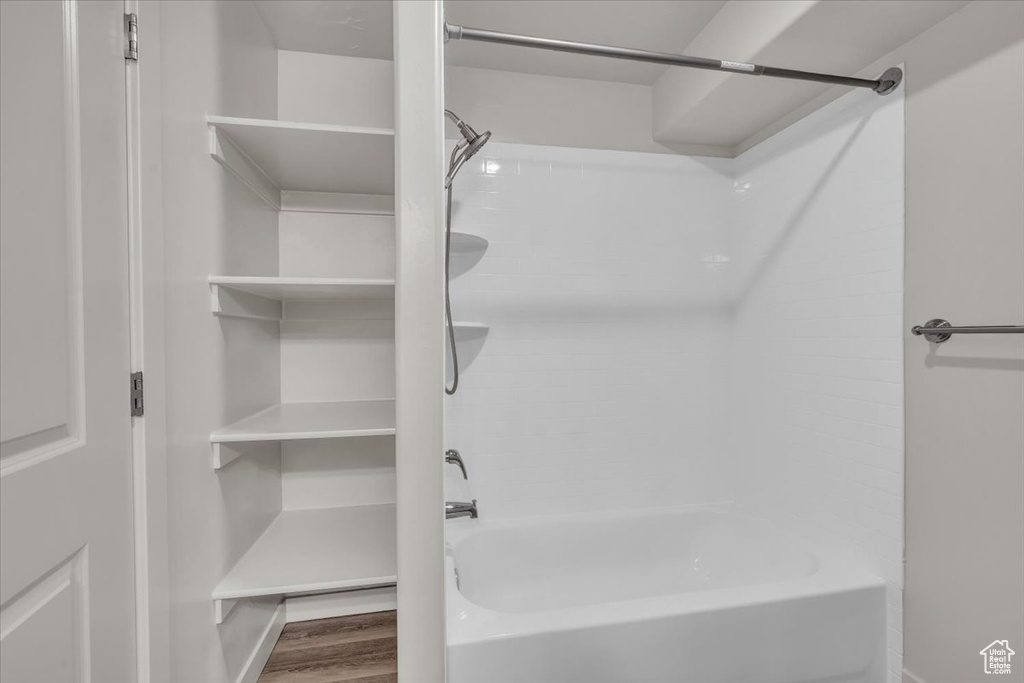 Full bathroom featuring shower / tub combination and wood finished floors