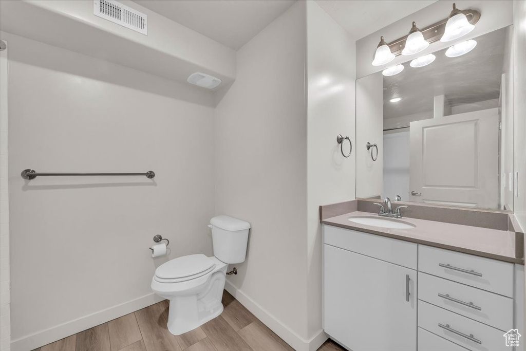 Bathroom featuring vanity and wood finished floors