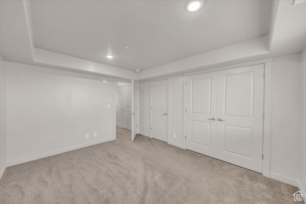 Unfurnished bedroom with carpet flooring, multiple closets, and recessed lighting