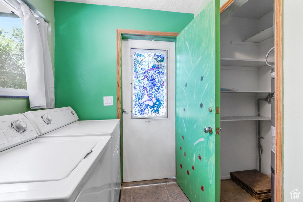 Washroom with washing machine and dryer and healthy amount of natural light