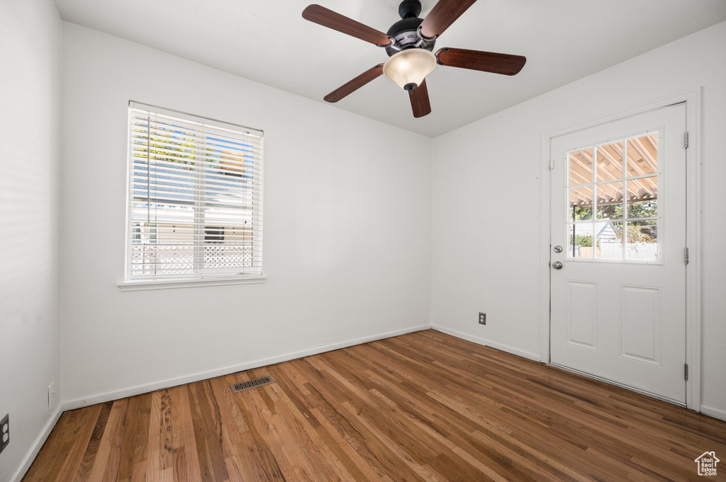 Empty room featuring wood finished floors and a ceiling fan