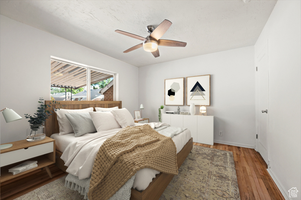 Bedroom with radiator, wood finished floors, and a ceiling fan