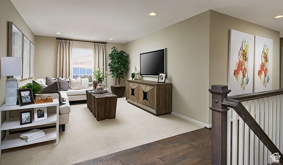 Living room featuring dark wood-type flooring and recessed lighting